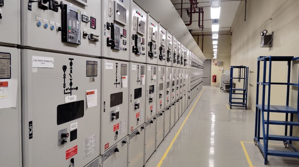 pexels-photo-33706880-33706880 Long row of control panels in an industrial electrical control room, well-lit and spacious.